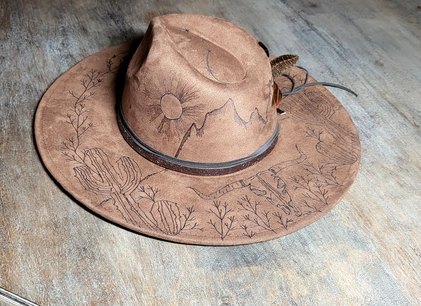 Introducing "Miranda" our desert sun scape suede fedora hat. Hand is burned on top and under her brim, fully adjustable