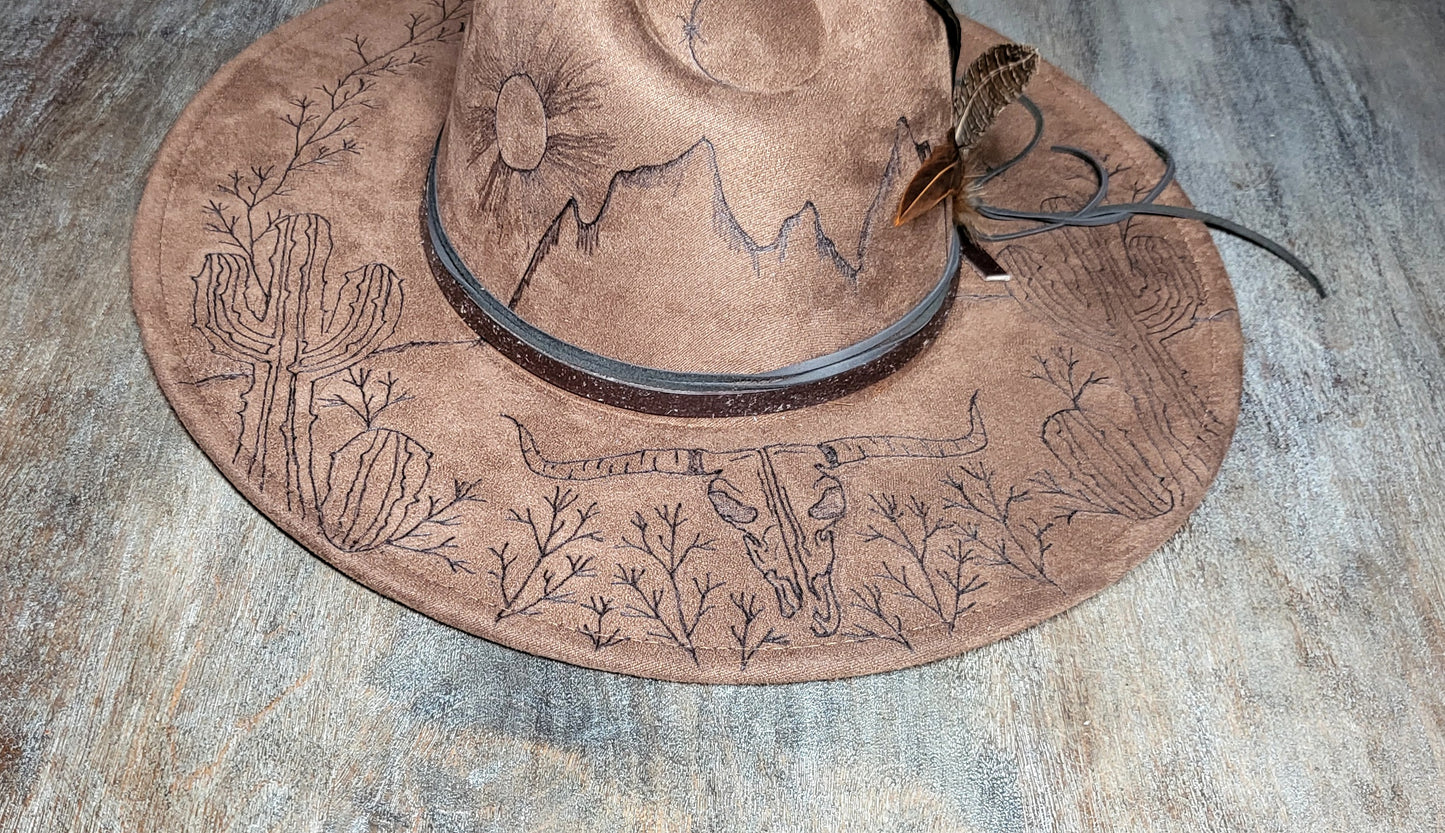 Introducing "Miranda" our desert sun scape suede fedora hat. Hand is burned on top and under her brim, fully adjustable