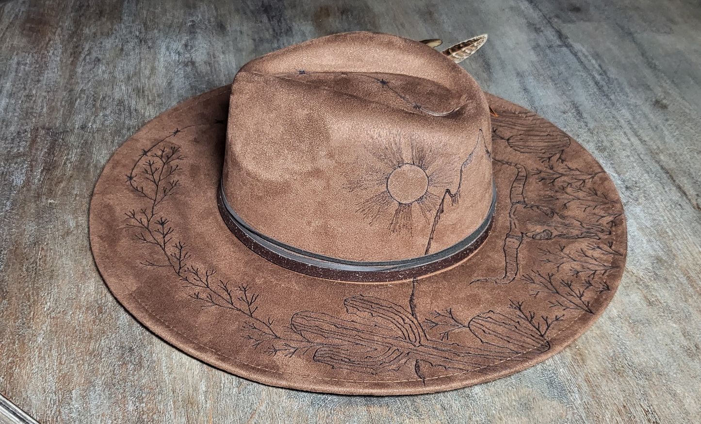 Introducing "Miranda" our desert sun scape suede fedora hat. Hand is burned on top and under her brim, fully adjustable