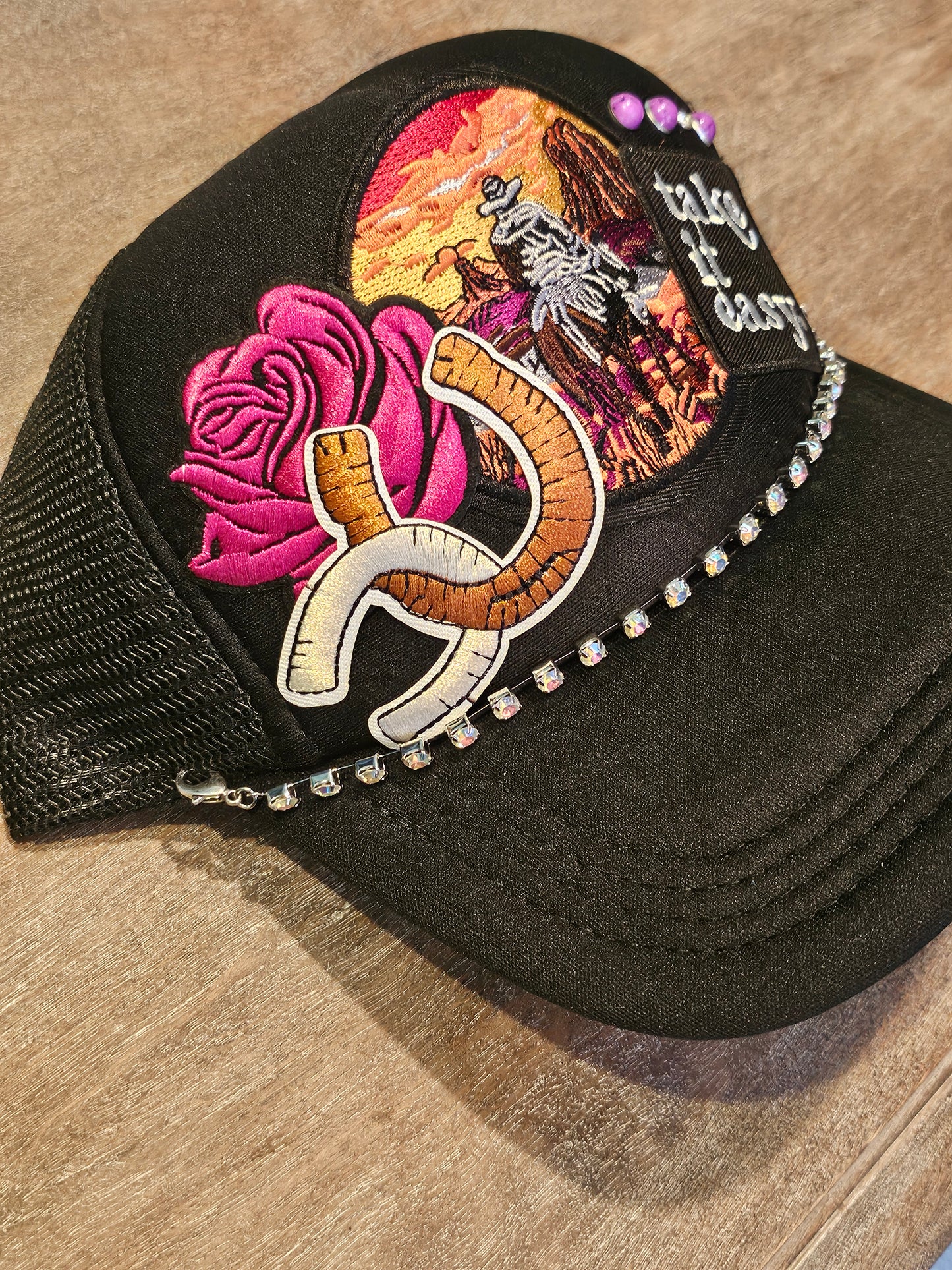 Custom "Take it easy" trucker hat with western style patches and accented with studs and a rhinestone hat chain