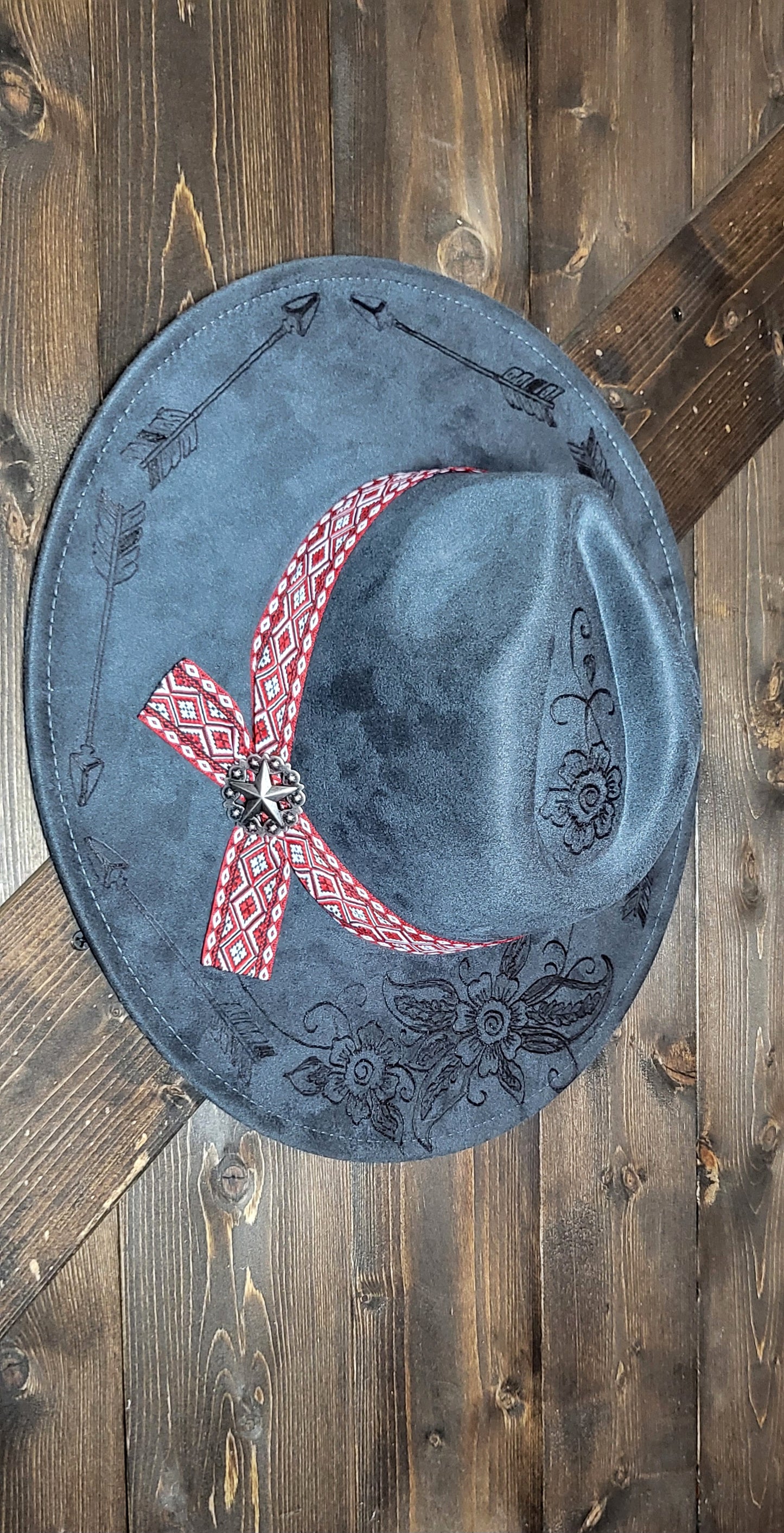 Grey suede burned cowboy hat fedora with the saying "forget the first arrow, only the next one counts"