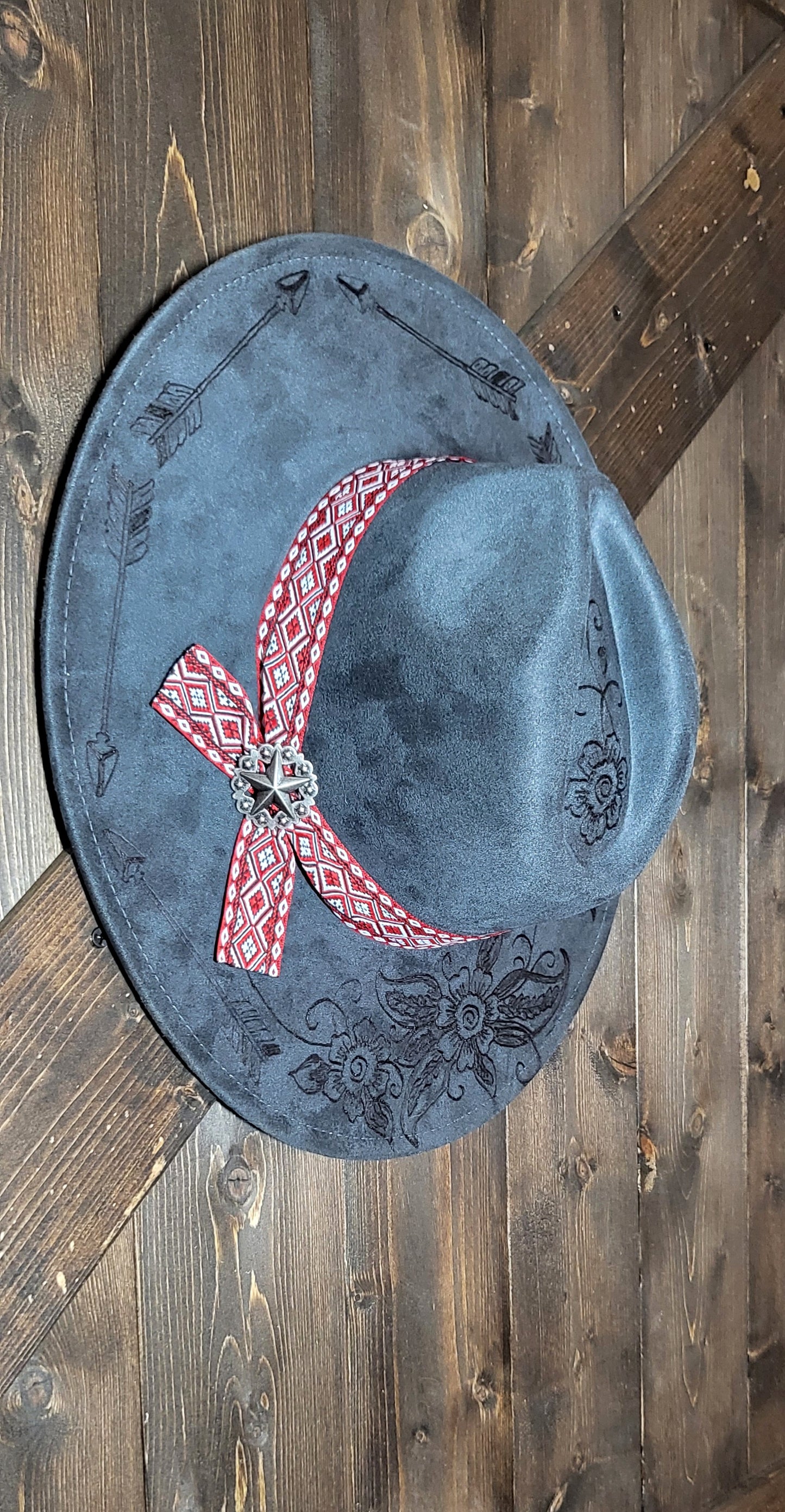 Grey suede burned cowboy hat fedora with the saying "forget the first arrow, only the next one counts"