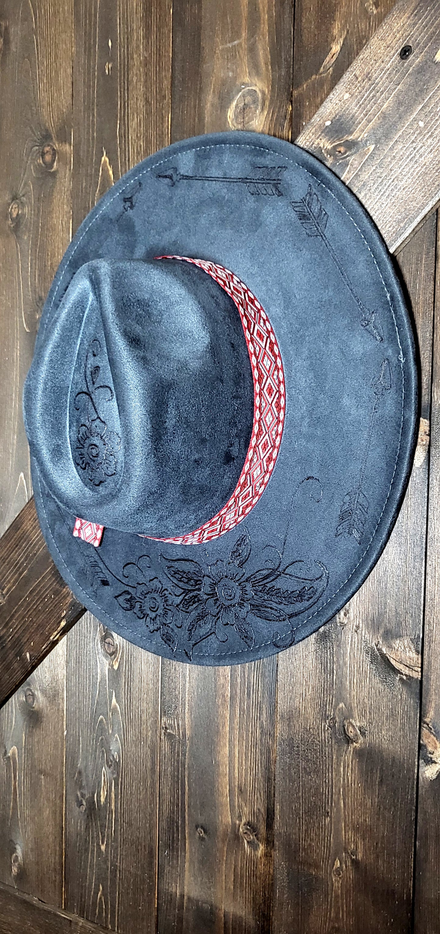 Grey suede burned cowboy hat fedora with the saying "forget the first arrow, only the next one counts"